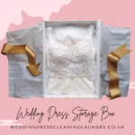 A white acid-free box with a wedding dress inside, suitable for long-term preservation.