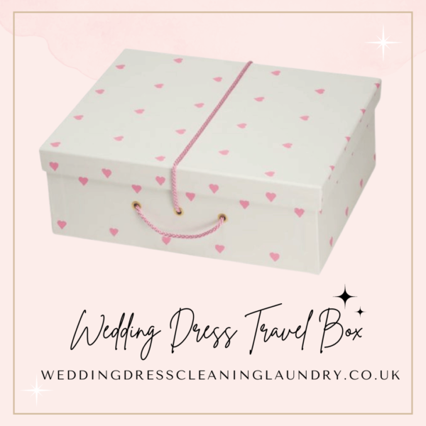 a white box with pink hearts on it. White wedding dress travel box with pink hearts, ideal for travel and storage.