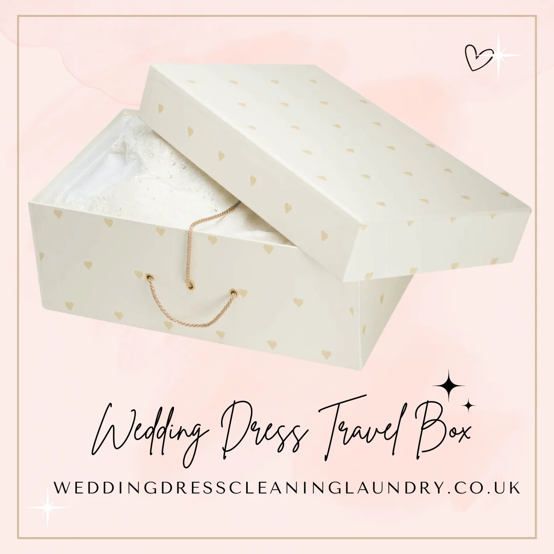 a white box with gold hearts on it. White wedding dress travel box with gold hearts, perfect for UK travel and storage.